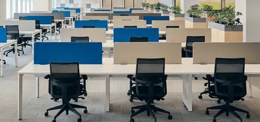 Modern open-plan office space featuring clean workstations, ergonomic chairs, and sanitized carpets provided by professional office cleaning services in Pasadena, CA.