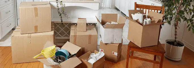 Packed moving boxes and household items in a kitchen before move-out or move-in cleaning, Pasadena, CA.